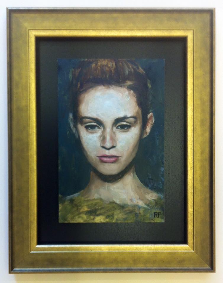 Self portrait in oil in a thick golden frame