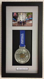 Presidential Ride London memorabilia medal in a black frame with a grey mount